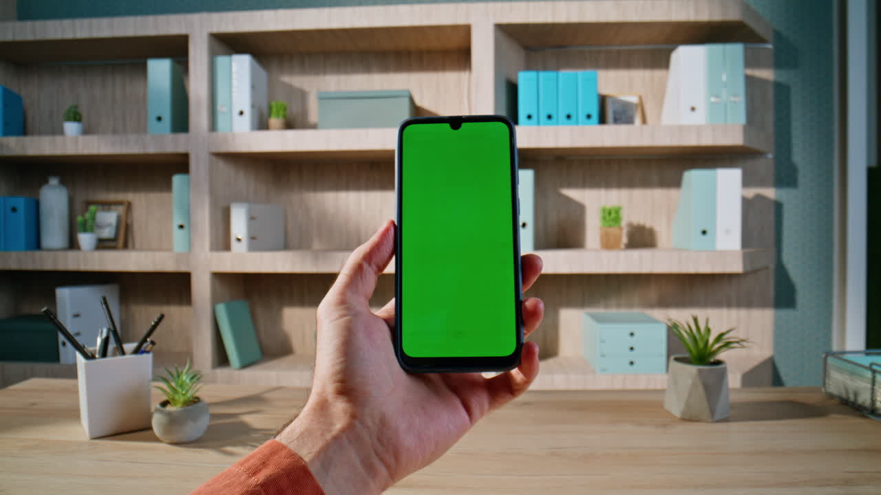 Guy browsing sms chroma key mobile phone sitting corporate office closeup