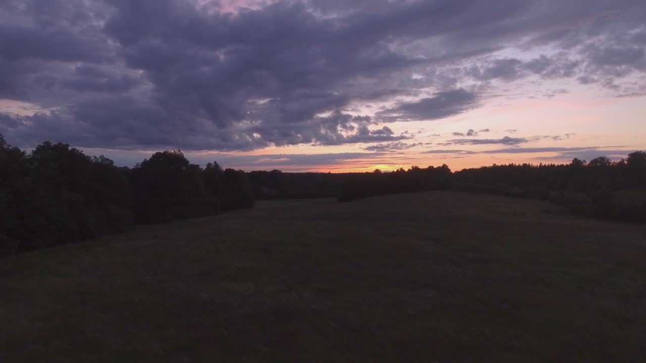 Sunset Sky Over Rural Area Late In The Evening. Aerial Track Left Pedestal Up Shot