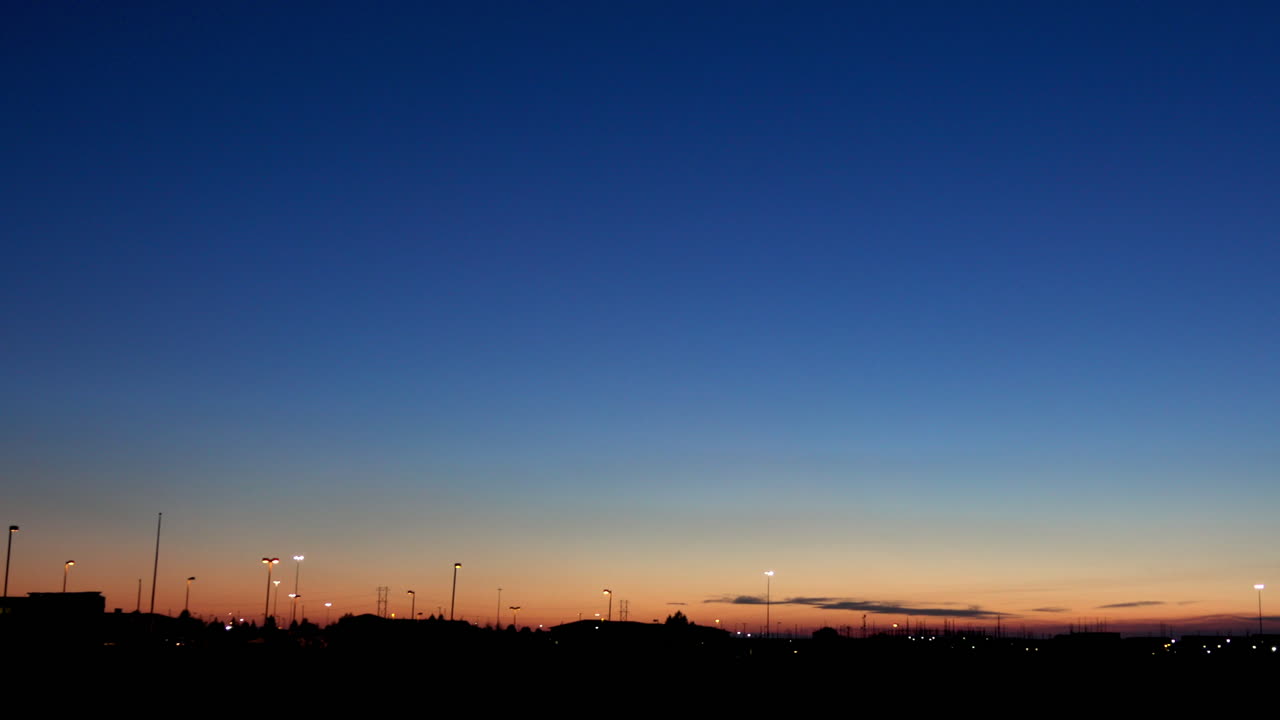 Pan right on twilight suburban horizon.