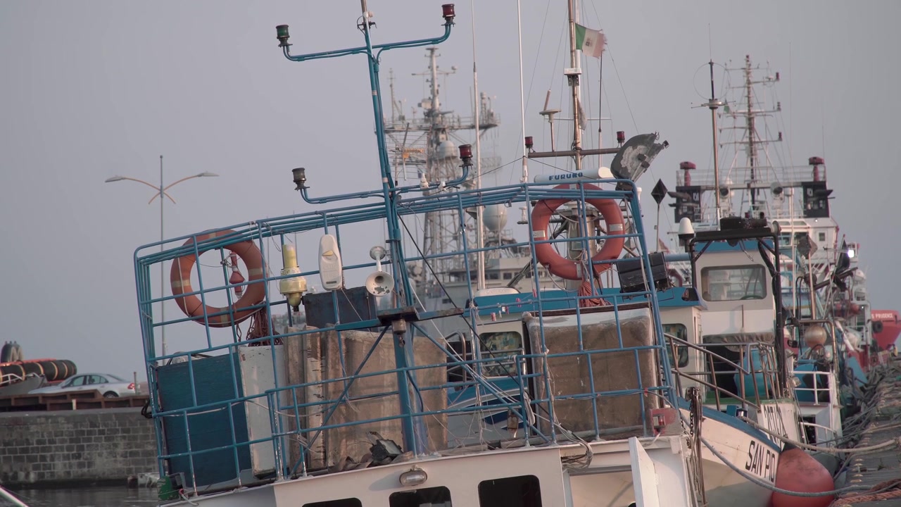 Boat bobbing on the waves at port in Catania, Italy