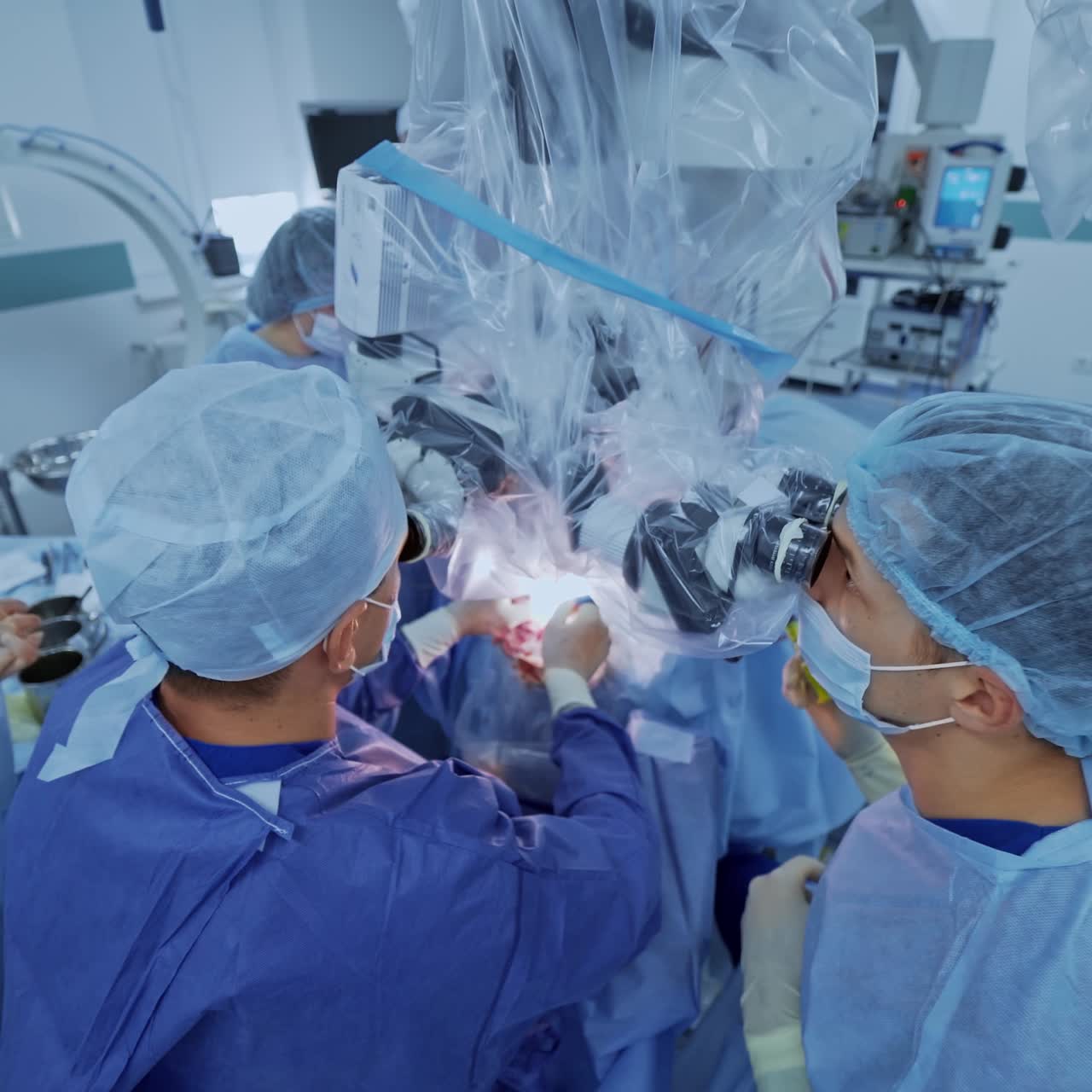 Neurosurgery in modern clinic. Team of professional doctors in medical uniform work with microscope during neurosurgery. New technologies in medicine. Top view.