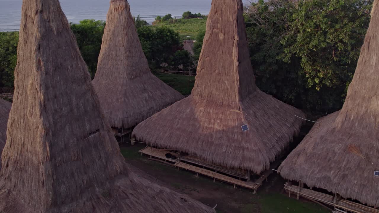 Close up of traditional village unique roofs at Sumba island during sunrise, aerial