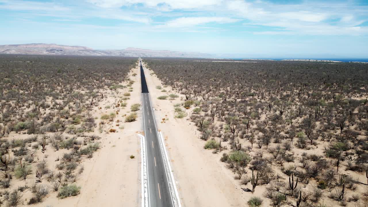 Endless desert road in La Paz, Mexico, stretching through barren landscape