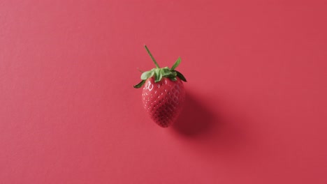 video of strawberry with copy space on red background