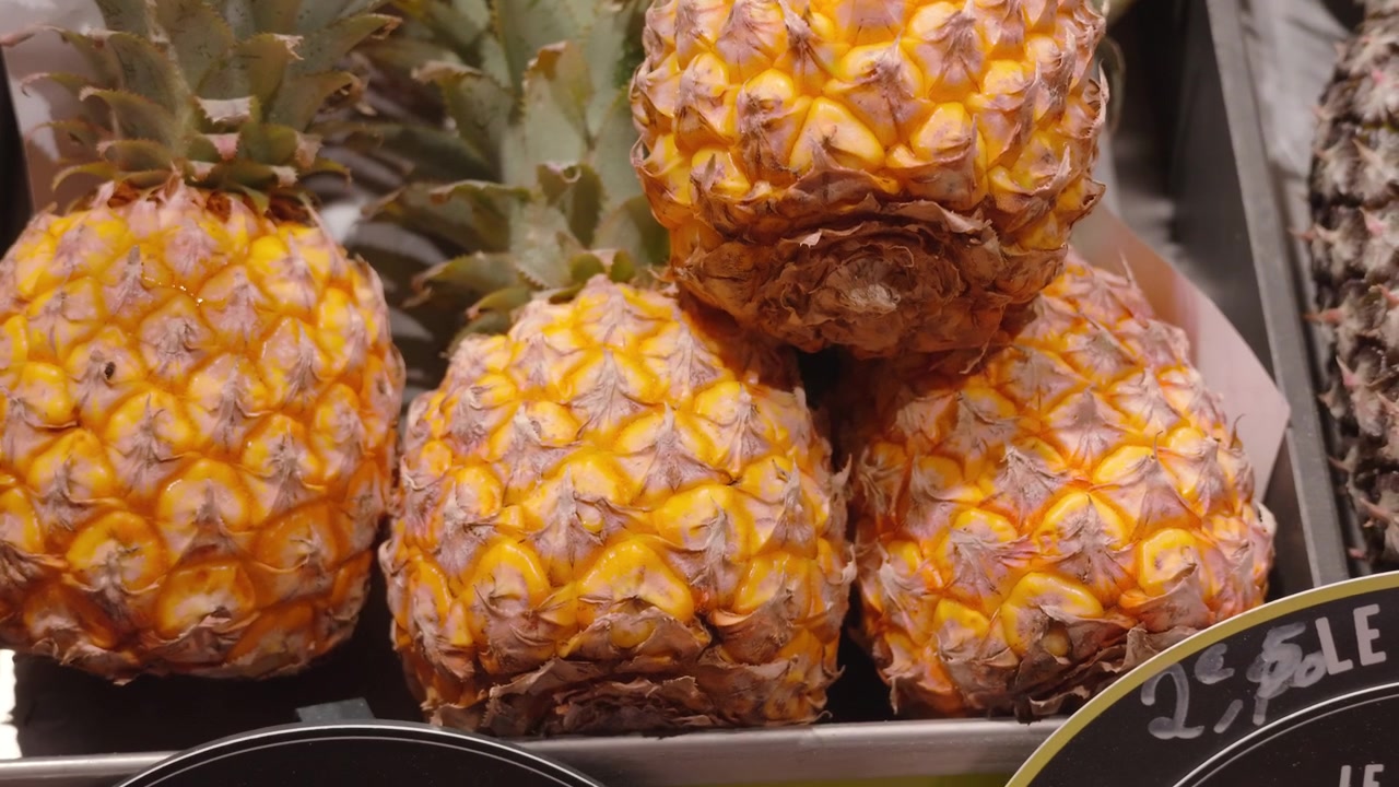 Close-up of fresh pineapples with spiky green crowns on display at a market, Cote d'Azur, France