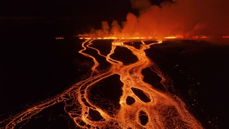 volcanic fissure eruption in iceland at night with rivers of lava flowing, aerial