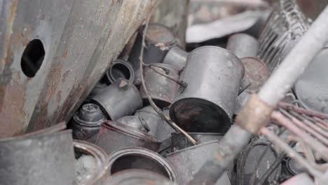 pile of burnt tin cans are some of the only remains in motor home park due to wildfires