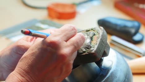 hands of craftswoman working in workshop