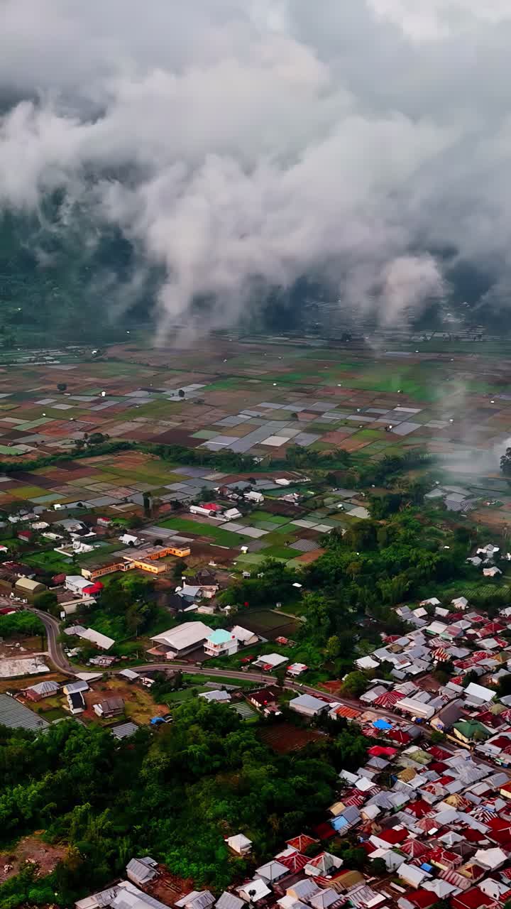 Aerial view of Bukit Selong village and fields under cloudy skies, Indonesia
