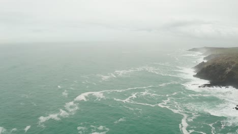 aerial rotation from the open atlantic ocean to the wild misty cornish coast