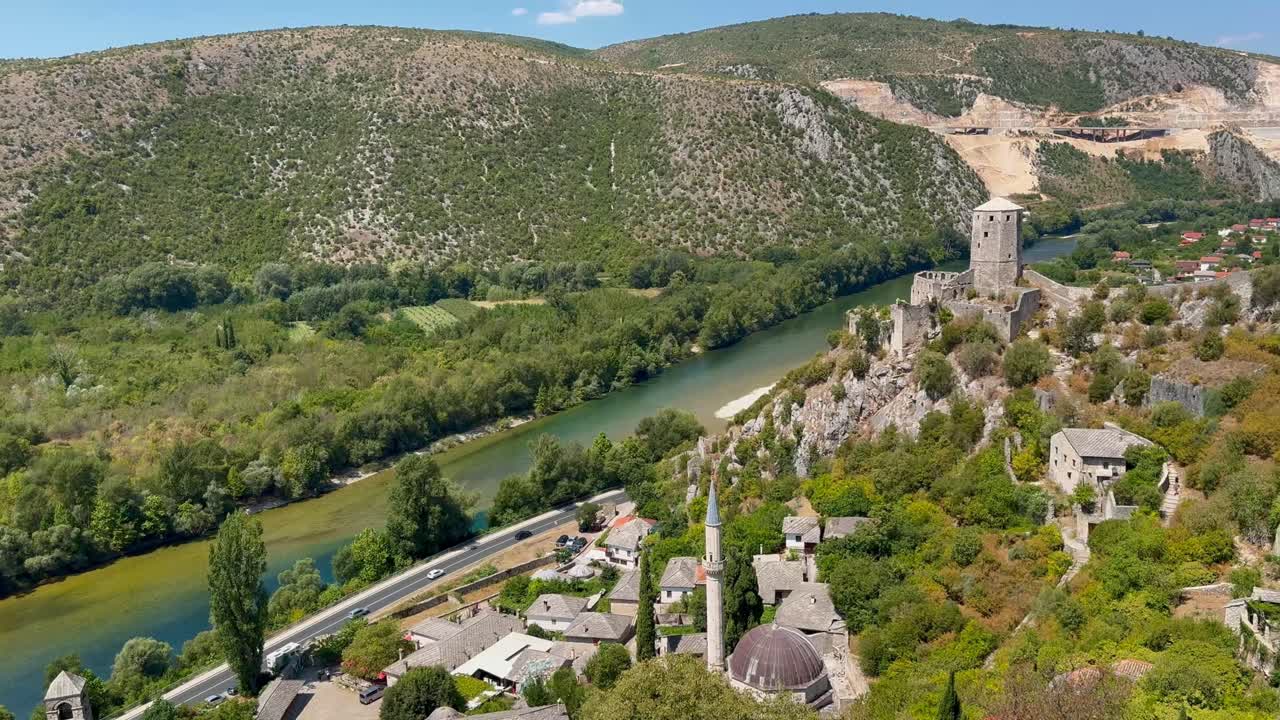 Sunny landscape view from Počitelj fortress overlooking Neretva River and old stone village on sunny summer's day - Počitelj, Bosnia and Herzegovina