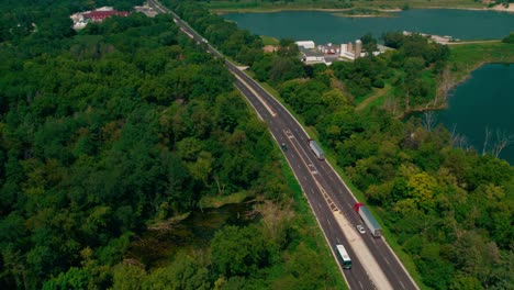 epic aerial of two red semi trucks and trailers driving on dundee ave