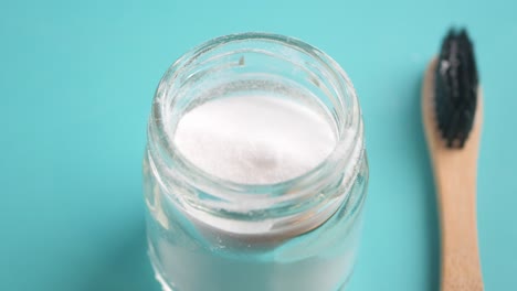 baking soda powder and wooden toothbrush