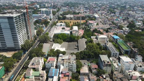 aerial drone shot capturing the dense urban landscape of hyderabad, with a mix of residential and commercial high-rises stretching into the horizon.