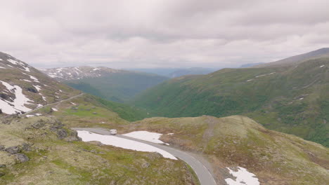 aerial drone above aurland road mountain pass valley norway scandinavian tourism cinematic landscape