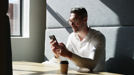 a mature businessman using a smartphone