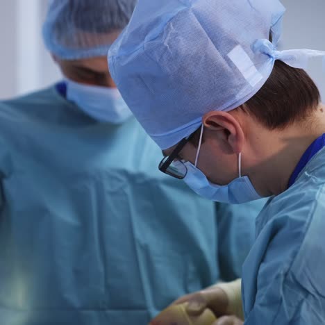 doctors working in operating room. team of professional surgeons and nurse conduct surgery to a patient with medical equipment. close-up