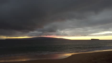 Cinematic-scenic-sunset-view-of-Molokini-Crater-and-the-sacred-Hawaiian-island-of-Kaho'olawe-along-with-the-southern-coast-of-Maui-in-Hawai'i