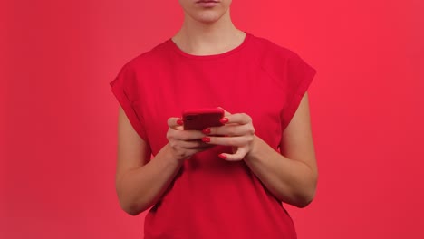 woman holding red smartphone with green screen