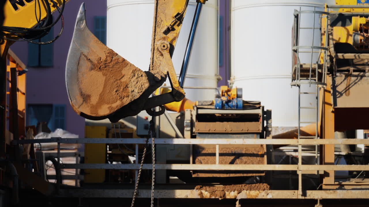 Close up of a yellow crane machine moving and lifting on a construction site