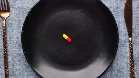 empty plate with a single pill