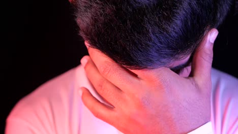 close-up of a young man with his head in his hands