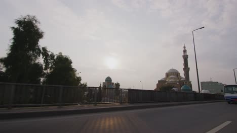 slow motion 60 fps shot driving past the jalil khayat mosque inside of a taxi near the citadel in erbil, iraq