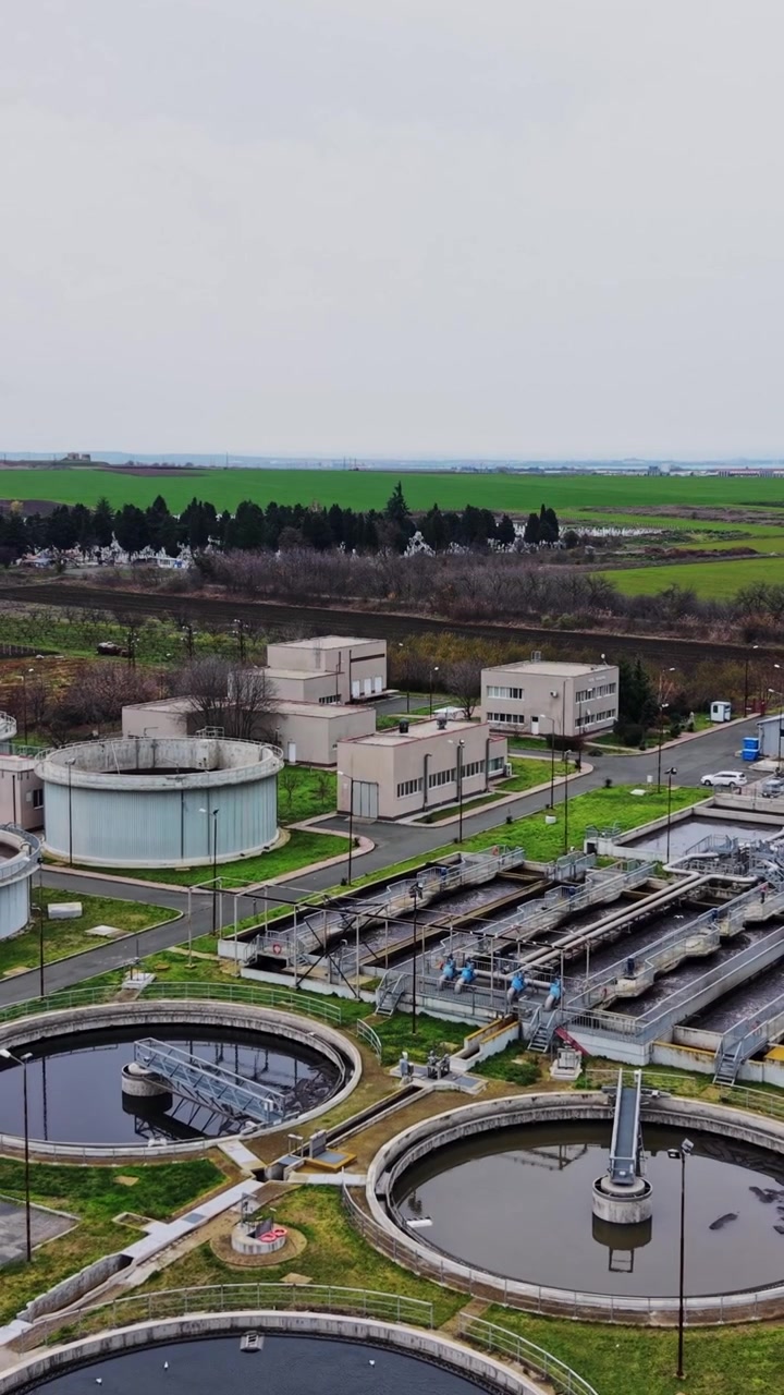 Wastewater treatment plant located in a rural area with tanks and buildings