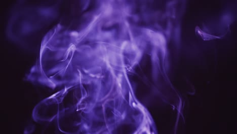 Video-of-purple-clouds-of-smoke-moving-with-copy-space-on-black-background