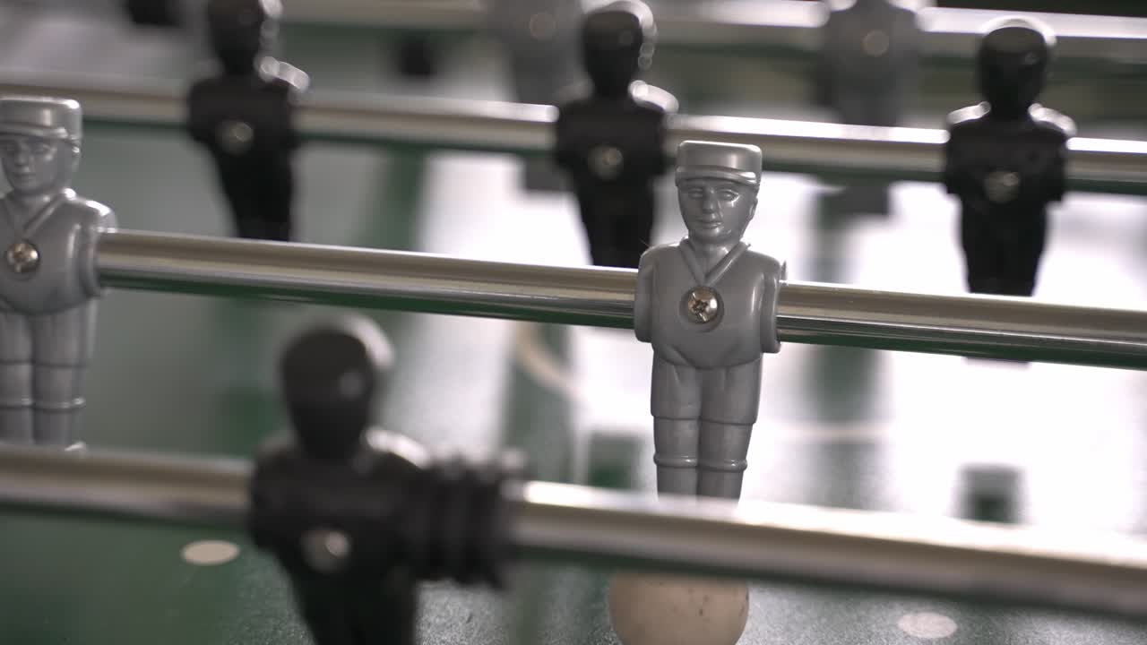 primer plano del personaje plateado de un juego de fútbol de mesa con el balón y la posibilidad de anotar