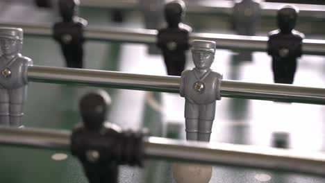 Clos up of silver character of a table soccer game with the ball and chance to score