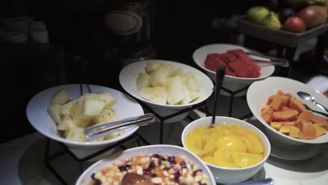 tropical fruit variety bar in breakfast display case in luxury hotel dining room