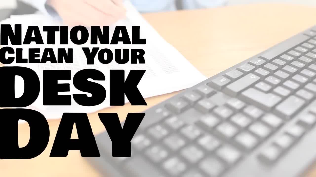 Animation of national clean your desk day text over hand of caucasian businesswoman writing