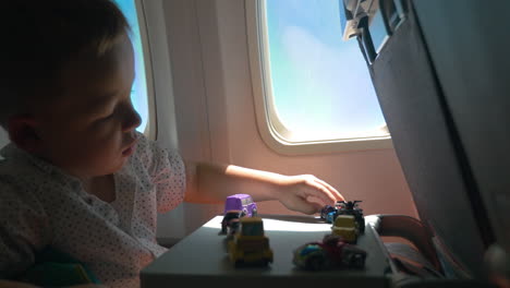 Close-up-of-little-boy-playing-toy-cars