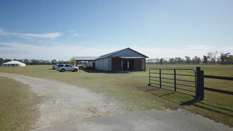 corrugated iron barn on farmland, wide gimbal shot tracking forward