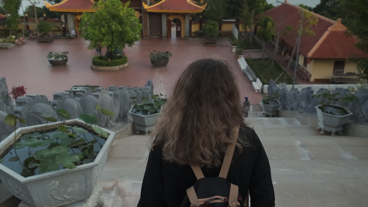 Woman Visiting a Temple Complex