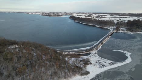 droneflight over a small bridge at a fjord in denmark in the winter