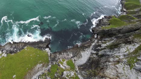 cliffdiving at a beach overlooking the ocean and then the beach in slowmotion