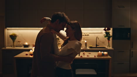 happy spouses dancing sensually at dark kitchen close up. couple evening date