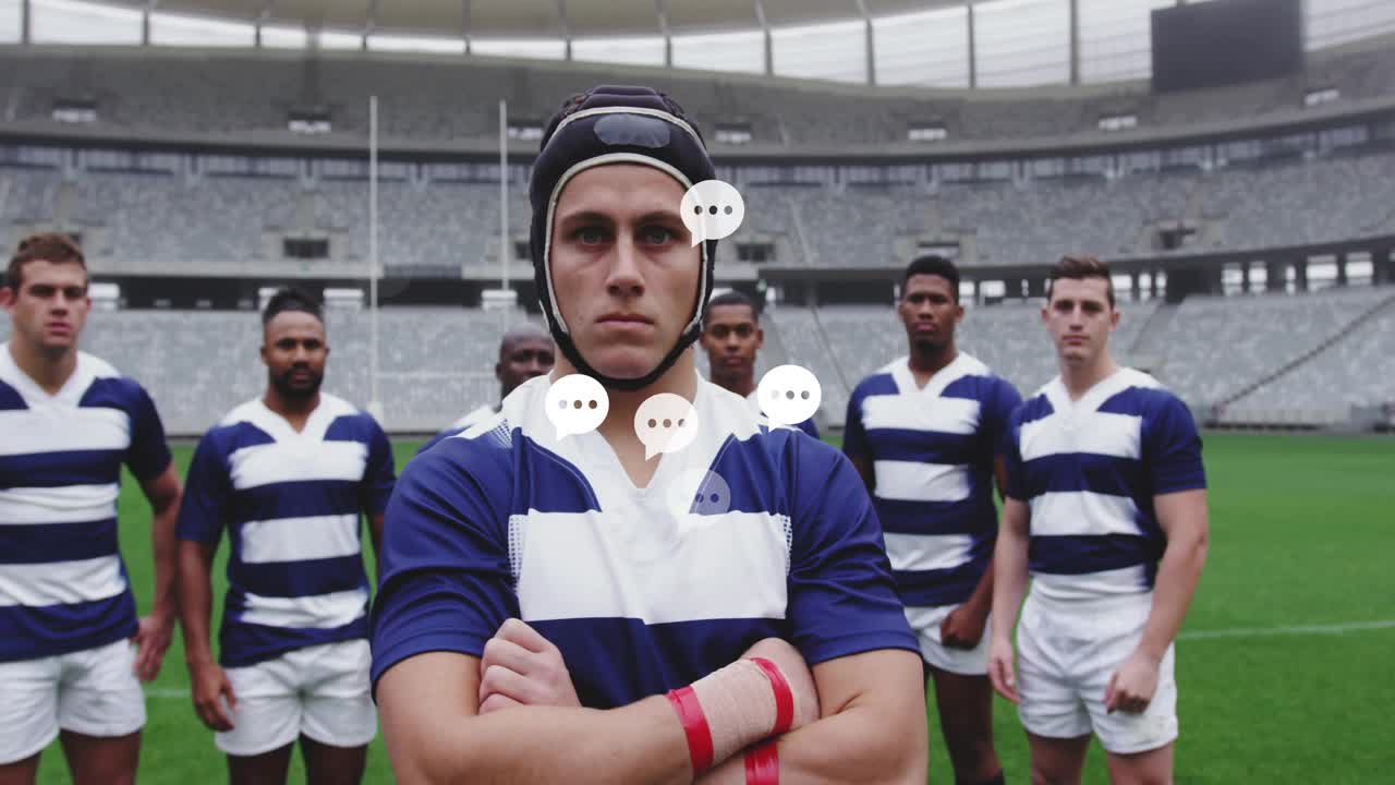 Una squadra di rugby si schiera in campo, il capitano incrocia le braccia, mentre bolle digitali appaiono, si raggruppano e svaniscono.