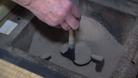 charcoal ashes are prepared inside a japanese shichirin charcoal stove