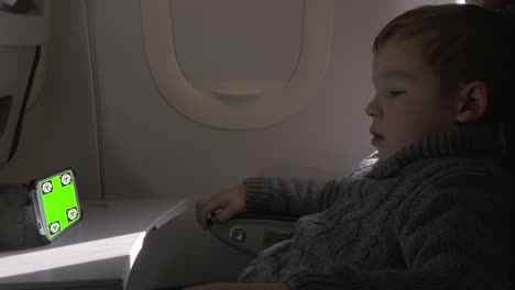 child watching something on smartphone in the airplane chroma key