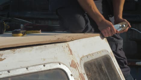 carpenter finishing plywood edge using handplane