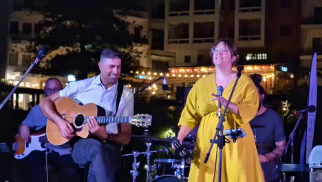 live band performing on stage, guitar play and vocal, agios nikolaos greece
