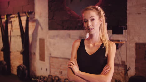 lockdown shot of beautiful confident young woman standing at fitness club