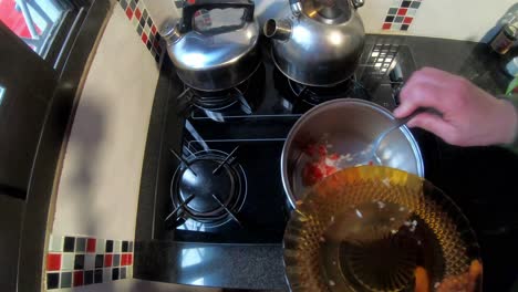 woman in the kitchen cooking sauce in a pot