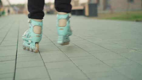 dynamic close-up shot of rollerblades in motion, smoothly gliding over a paved path in a park. movement and energy of outdoor skating, focusing on the rollerblade wheels as they roll over the surface