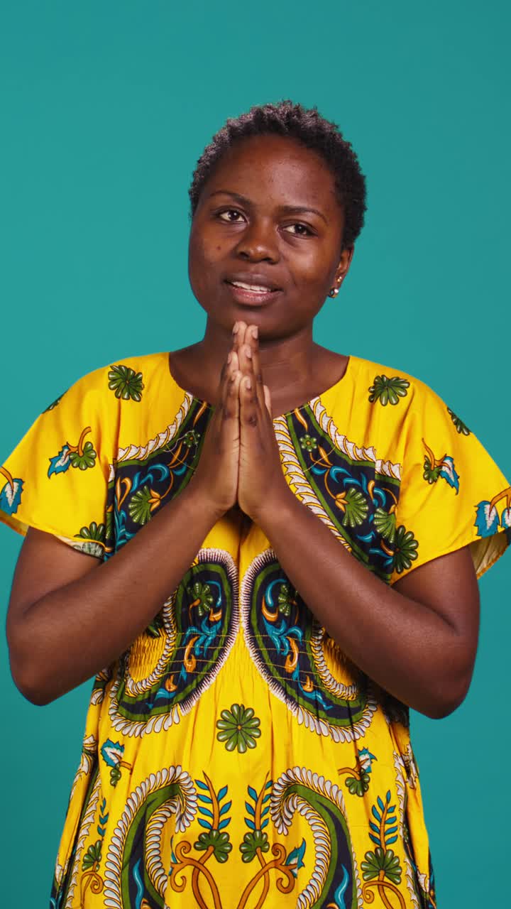 Young African Woman Making Namaste Gesture and Smiling