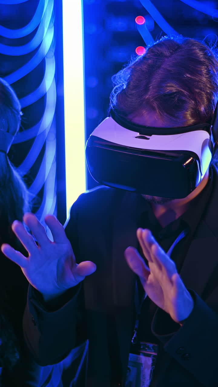A man and a woman using Virtual Reality headsets in a server room. Vertical