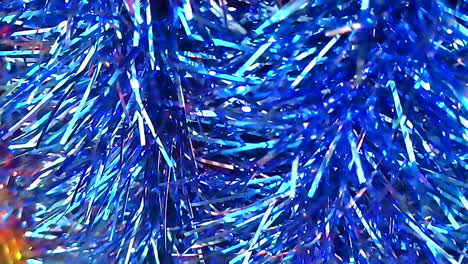 Christmas-decorative-embellishment,-hanging-tinsel-material-of-shining-blue-in-slow-motion